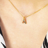 Image shows model wearing dainty rainbow alphabet initial necklace with initial A