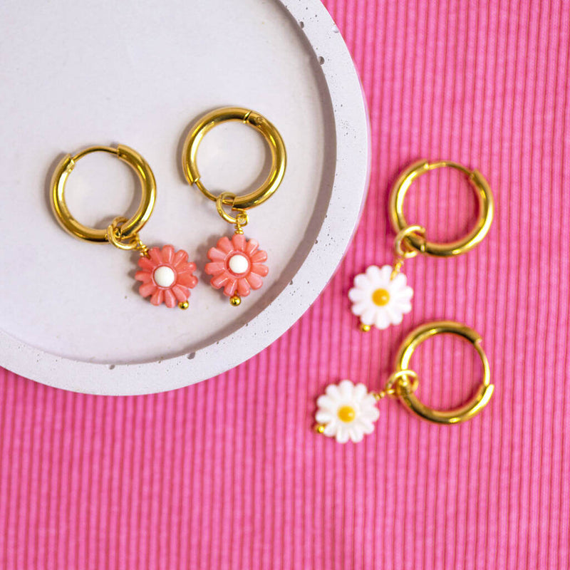 Image shows daisy charm Huggie hoop earrings