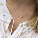 Gold outline hexagon necklace with 4mm February amethyst birthstone attached