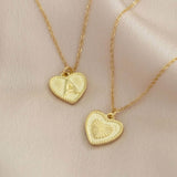 Image shows two gold dotted heart initial charm necklace with the initial A and heart