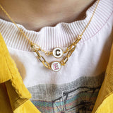 Image shows model wearing double initial friendship spinner necklace with the initials C & E