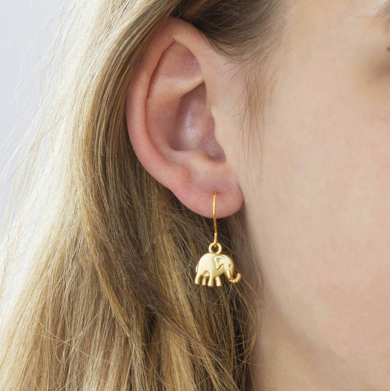 mage shows model wearing elephant charm drop earring 