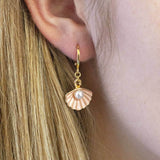 Image shows model wearing pale pink Enamel Shell Earrings with Pearl Detail