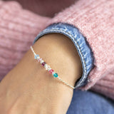 Image shows model wearing family birthstone bar bracelet