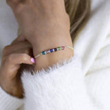 Image shows model wearing family birthstone bar bracelet  