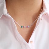 Image shows model wearing family birthstone bar necklace