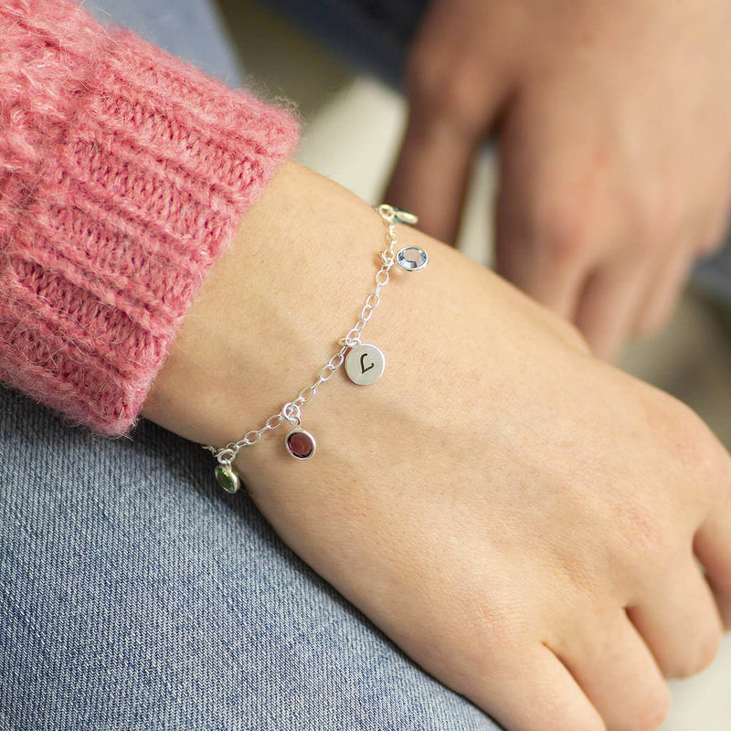 Image shows model wearing family birthstone charm bracelet