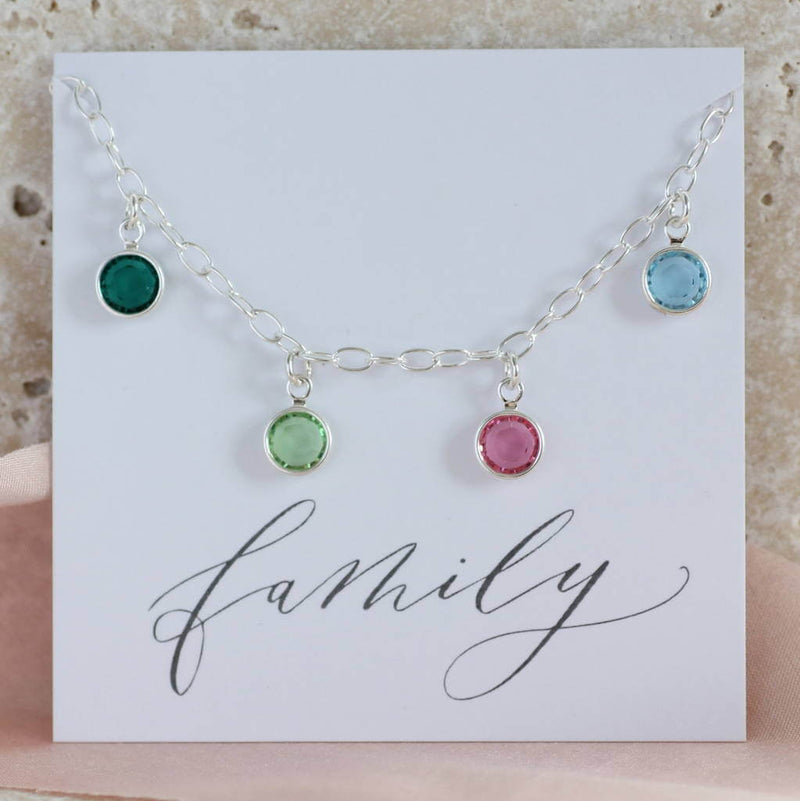 Image shows family birthstone charm bracelet on a family sentiment card
