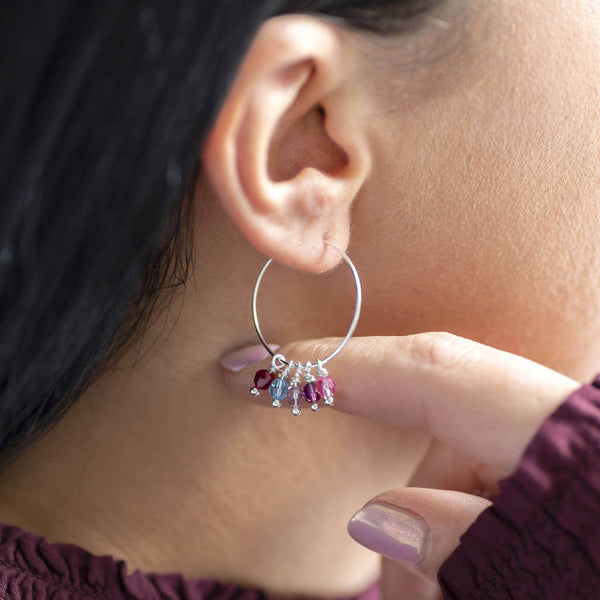 Image shows model wearing family birthstone hoop earrings