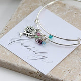 Image shows family tree birthstone bangle sitting on a Family sentiment card