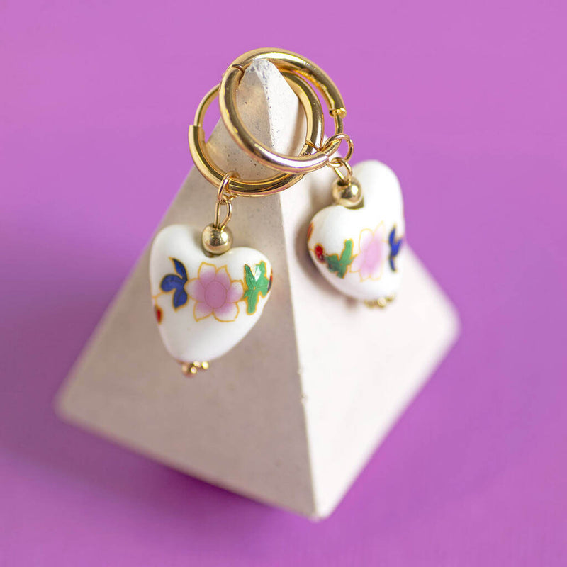 Image shows Floral Porcelain Heart Huggie Earrings