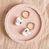 Image shows Floral Porcelain Heart Huggie Earrings in a light pink trinket dish