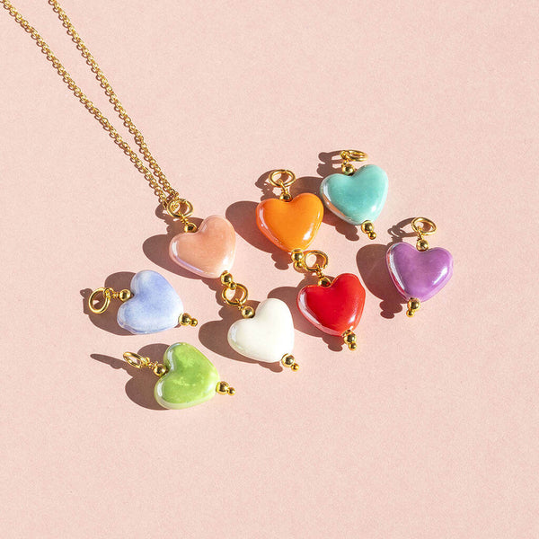 Image shows blue, pink,orange,turqoise,green.white.red and Purple Hearts from Four in One Glazed Ceramic Heart Necklace