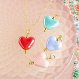 Image shows. red, blue, pink and turquoise  Hearts from Four in One Glazed Ceramic Heart Necklace