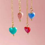 Image shows. red, blue, pink and turquoise Hearts from Four in One Glazed Ceramic Heart Necklace