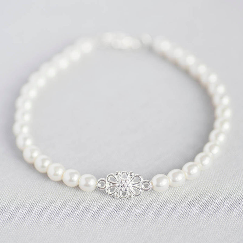 Silver friendship knot pearl bracelet on a white background