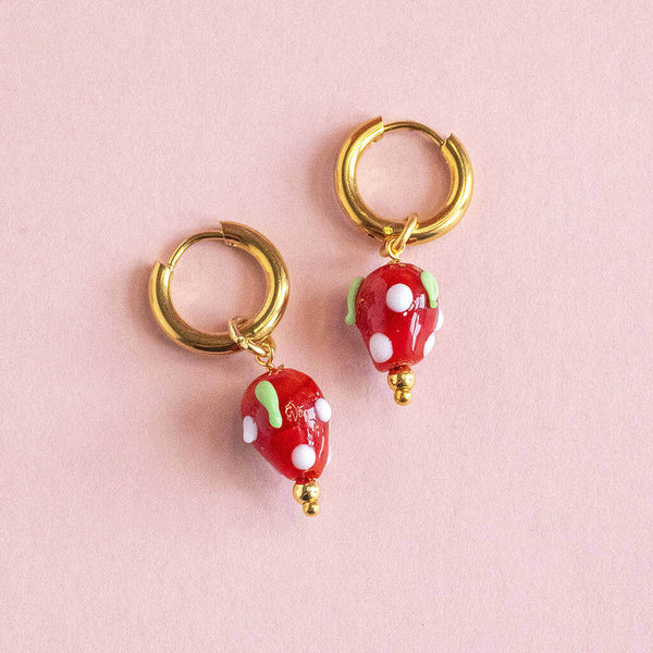 Image shows gold plated hoop earrings with strawberry charms
