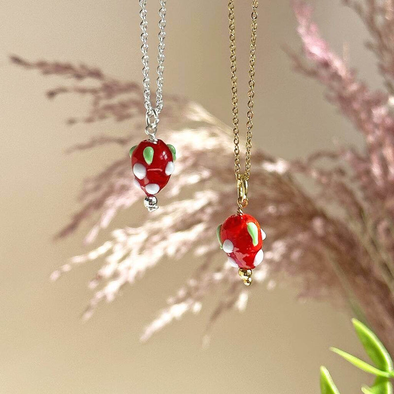 Images shows gold plated and silver plated strawberry necklaces