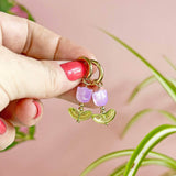 Image shows model holding lilac Glass Tulip Huggie Hoop Earrings