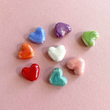 Image shows orange, blue,purple,green,pink,turquoise,redand white glazed hearts