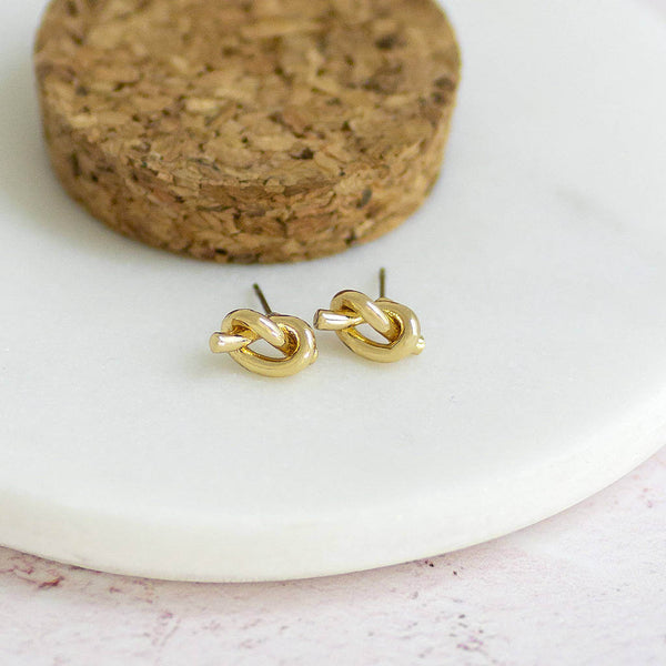 Image shows gold friendship knot stud earrings