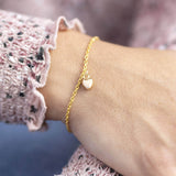 Image shows model wearing Gold Heart Charm Bracelet