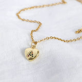 Image shows gold heart necklace with rainbow alphabet letter A