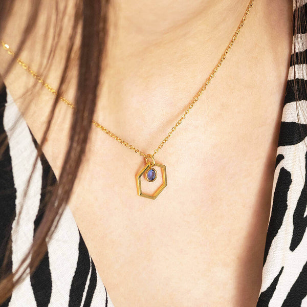 Image shows model wearing Gold Hexagon Birthstone Charm Necklace with September birthstone
