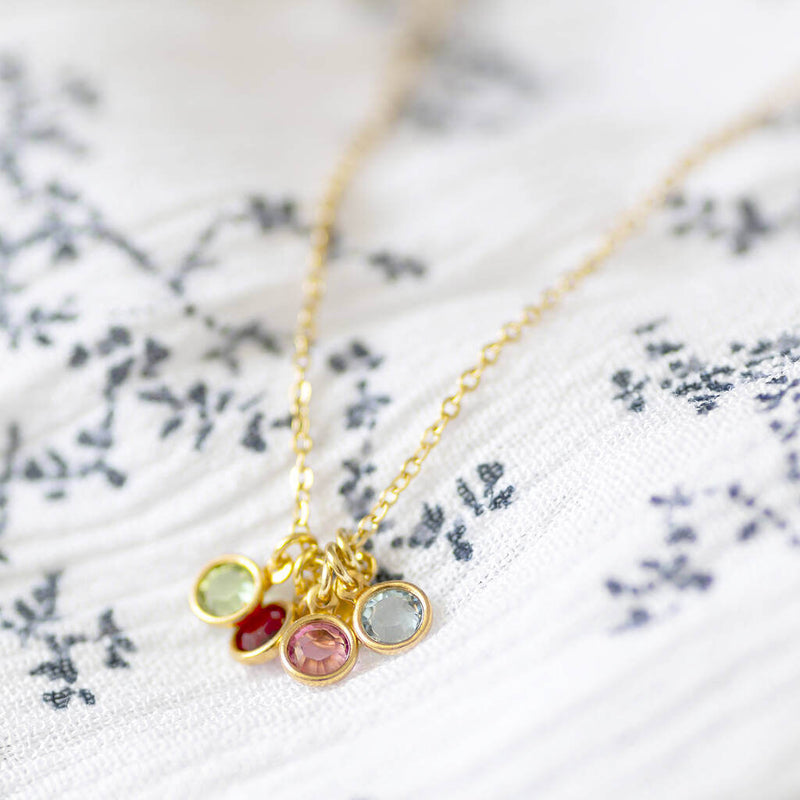 Image shows gold mini family birthstone charm necklace  Edit alt text