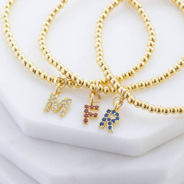 Image shows three Gold Plated Beaded Bracelet With Birthstone Initial