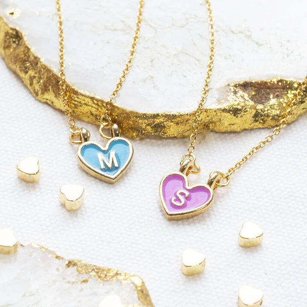 Image shows two gold plated enamel heart initial necklaces with M and S initials
