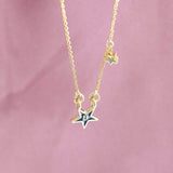 Image shows hanging gold plated enamel star initial necklace with the initial B 