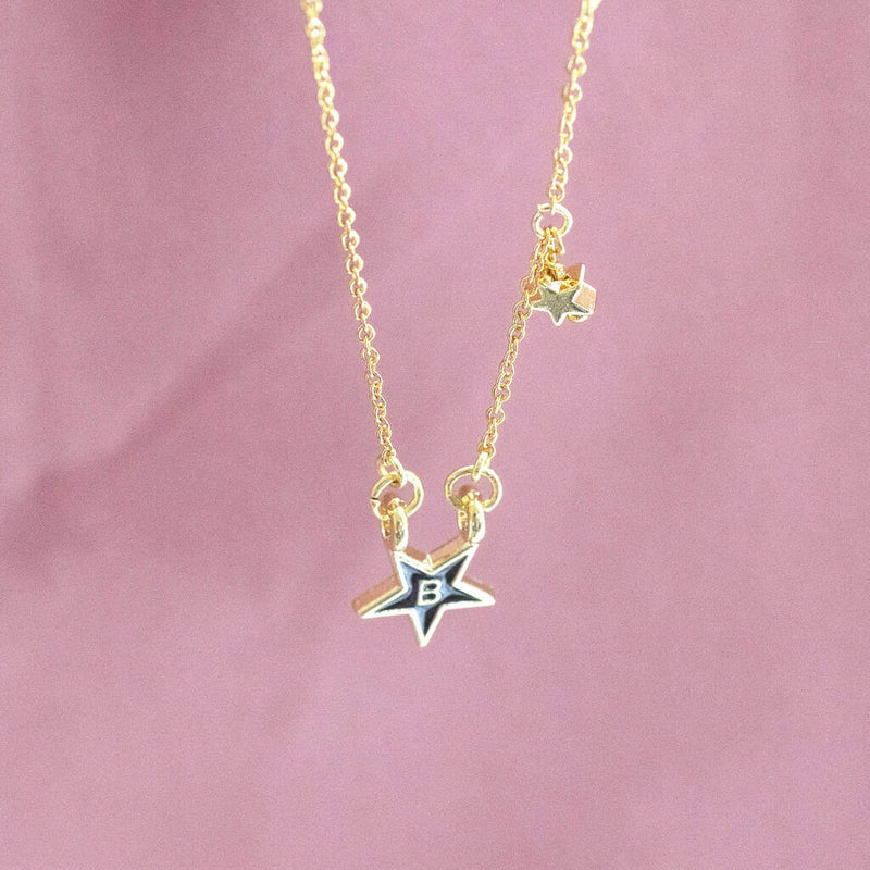 Image shows hanging gold plated enamel star initial necklace with the initial B 