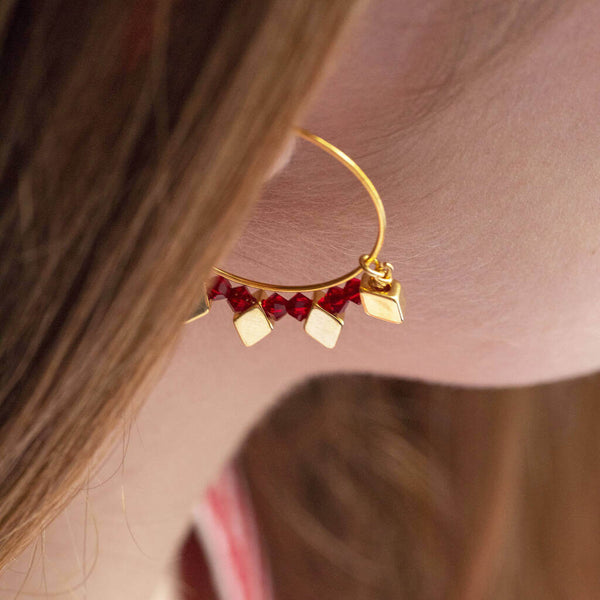 Image shows model wearing Gold Plated Rhombus And Birthstone Hoop Earrings with July birthstones