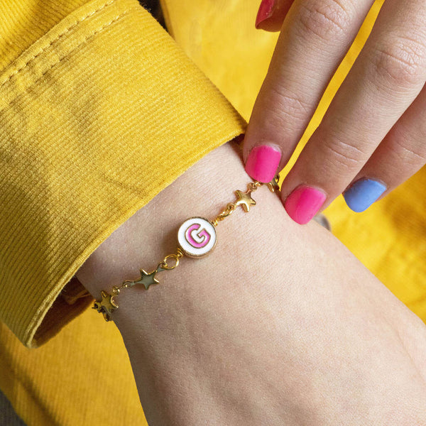 Image shows model wearing Gold Plated Stars Bracelet With Enamel Initial G