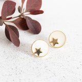 Image shows gold star circle stud earrings in ivory