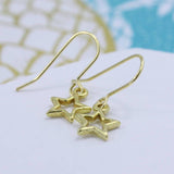 Image shows gold star earrings
