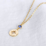 Image shows gold starburst birthstone necklace with September birthstone