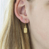Image show model wearing gold owl earrings