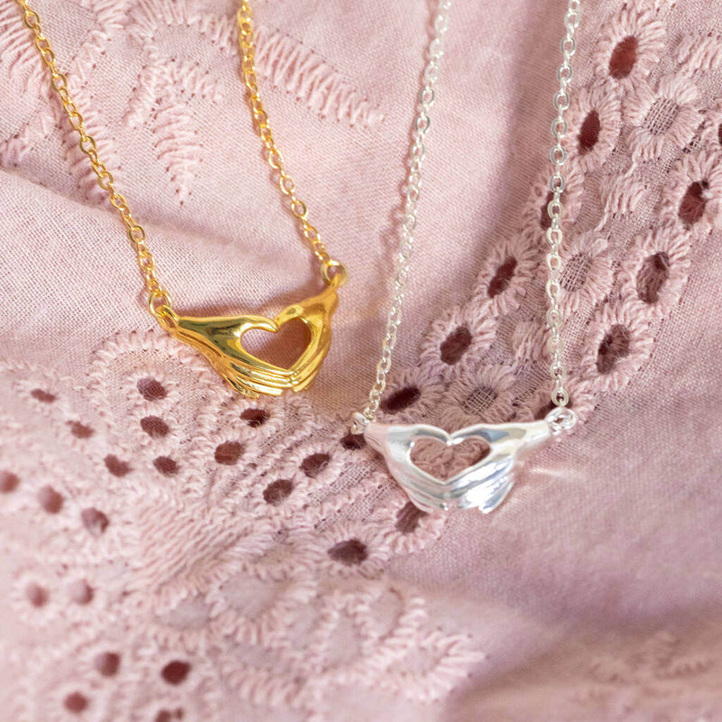 Image shows  a gold and silver Hands in Love Sign Necklace