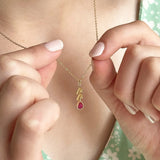 Image shows leaf chain necklace with Ruby July birthstone