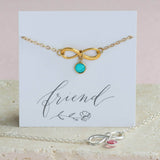 Image shows gold  Infinity Birthstone Charm Bracelet on a friend sentiment card