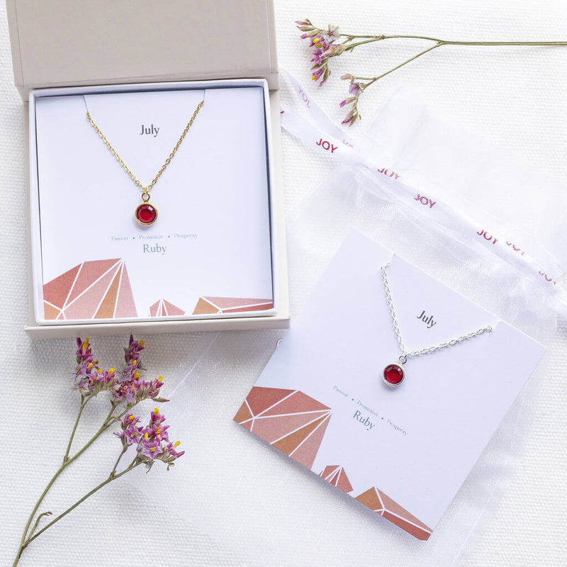 Image shows July Birthday Ruby Birthstone Necklace in a gift box on a July characteristic birthstone card