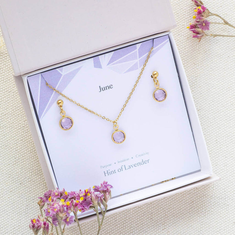 Image shows gold June Birthstone Light Amethyst Jewellery Set in gift box on a June birthstone characteristic card 