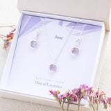 Image shows silver June Birthstone Light Amethyst Jewellery Set in gift box on a June birthstone characteristic card