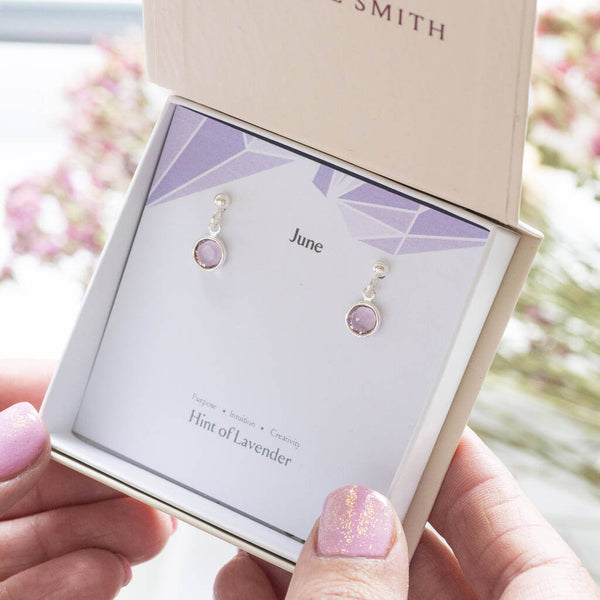 Image shows model holding silver June Birthstone Swarovski Crystal Drop Earrings in a gift boson a June birthstone charactaristic card