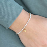 Image shows model wearing lucky horseshoe beaded charm bracelet