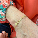 Image shows model wearing Mama Bracelet