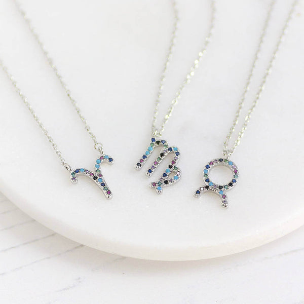 Image shows a selection of silver micro pave rainbow zodiac necklace