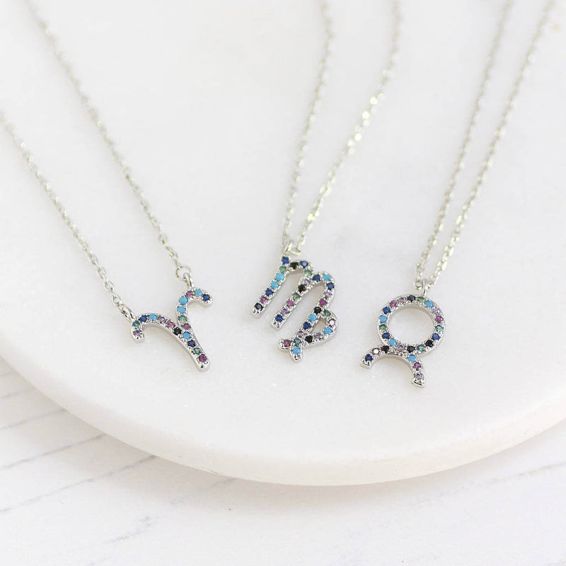 Image shows a selection of silver micro pave rainbow zodiac necklace